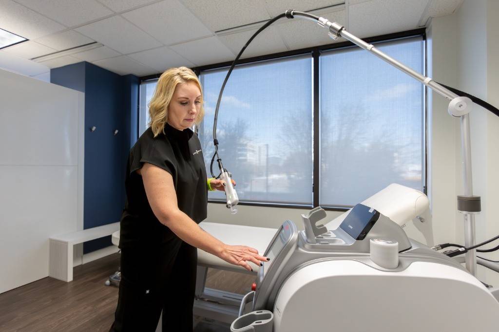 A Virginia Laser Specialists technician setting up the Clarity II in a private treatment room