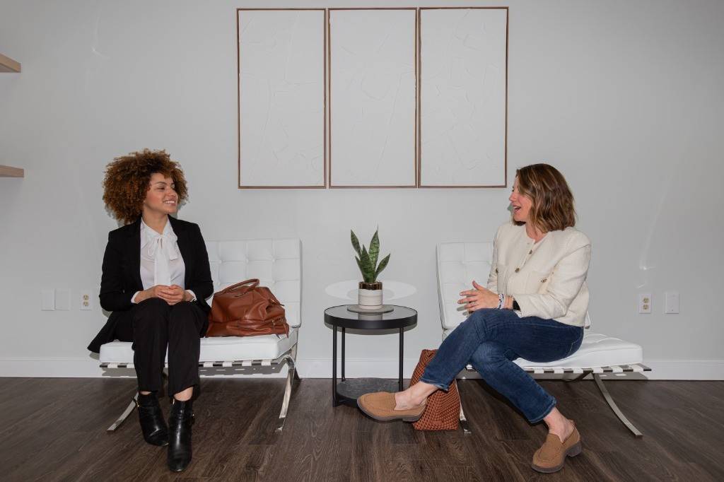 Two people talking in the waiting area at Virginia Laser Specialists